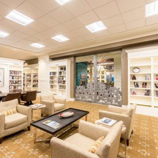 A cozy and modern library interior with comfortable seating and well-organized bookshelves.