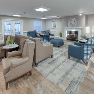 A modern and cozy living room with comfortable seating and a fireplace.