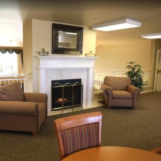 A cozy living room with a fireplace and comfortable seating.