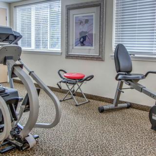 A small gym room with various exercise equipment.