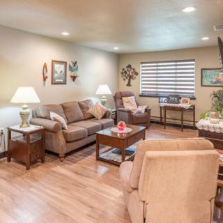 A cozy living room with comfortable seating, bright lamps, and stylish decor.