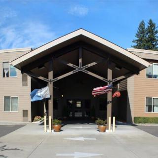 Entrance of a building with a covered walkway and flags.