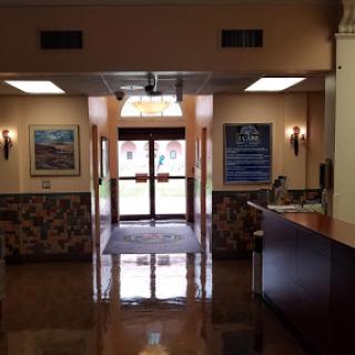 A welcoming lobby with a reception desk and artwork on the walls.