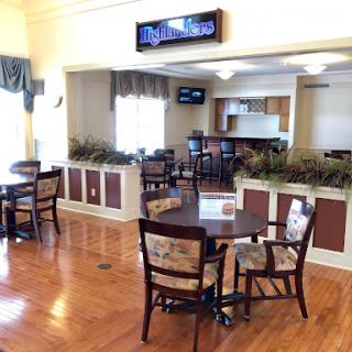 A bright and inviting dining area featuring wooden furniture and a welcoming ambiance.
