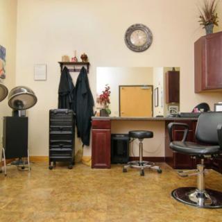 A neatly organized hair salon interior with chairs, mirrors, and hair styling equipment.