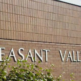 The exterior of a building featuring the words 'Pleasant Valley' prominently displayed.