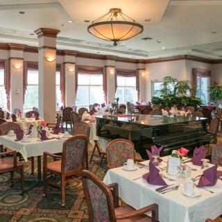 An elegantly decorated restaurant interior with neatly arranged dining tables and chairs.