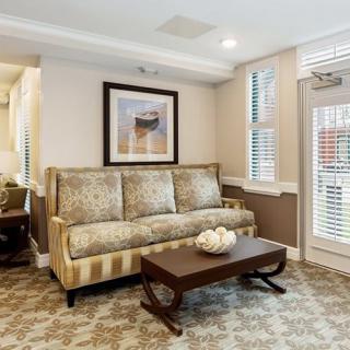 A cozy living room with a patterned sofa, a sleek coffee table, and elegant decor.