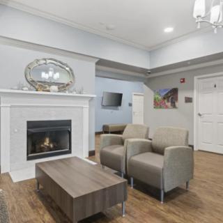A modern living room with a fireplace and comfortable seating.
