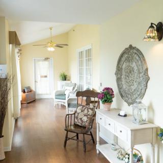A cozy, well-lit hallway featuring elegant furniture and wall decor.