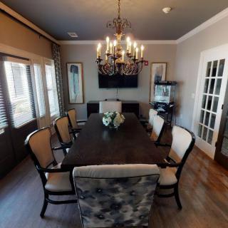 A beautifully decorated dining room with a large table and chandelier.