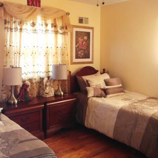 Cozy bedroom with twin beds and elegant decor.