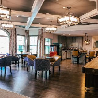 A modern lounge area with comfortable seating and elegant chandeliers.