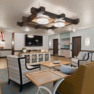 A modern and cozy living room with stylish furniture and unique lighting fixtures.