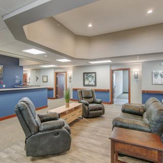 A cozy waiting room featuring comfortable seating and a welcoming atmosphere.