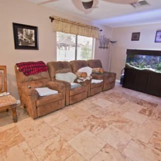 Cozy living room with a large aquarium and comfortable seating.