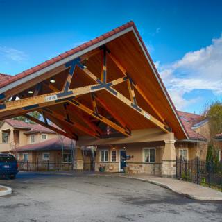 A residential building with a distinctive wooden canopy at the entrance.