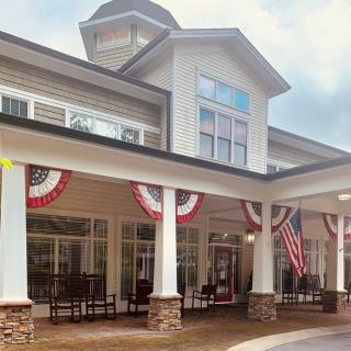 A building decorated with American flags and patriotic bunting.