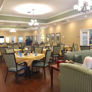 A cozy dining area with elegantly set tables and comfortable seating.