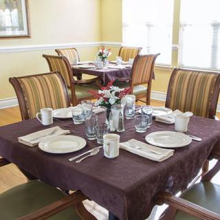 A neatly set dining table in a cozy restaurant setting.