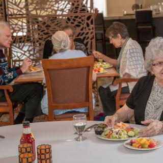 A group of seniors enjoying a meal together in a cozy dining environment.