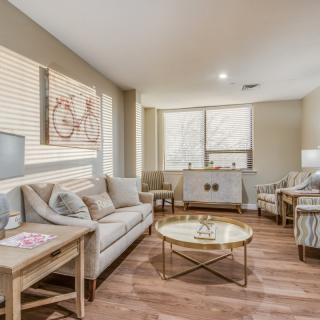 A cozy living room with a modern design featuring a comfortable sofa, armchairs, and a stylish coffee table.