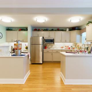 A modern kitchen with stainless steel appliances and hardwood flooring.