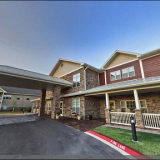 An inviting care facility showcasing modern architecture and well-maintained landscaping.