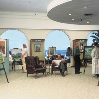 Visitors exploring an art exhibition in a spacious gallery setting.