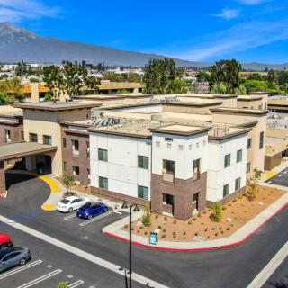 Aerial view of a modern office building with a parking lot.