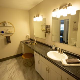 A modern bathroom with a spacious countertop and elegant lighting.