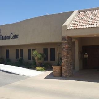 A view of a healthcare facility under clear blue skies.