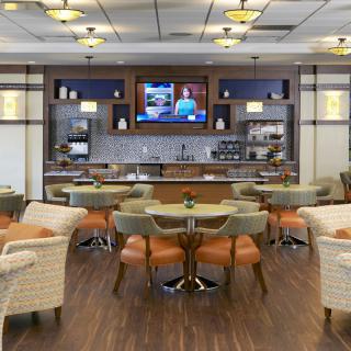 A modern restaurant interior with a seating area and bar.