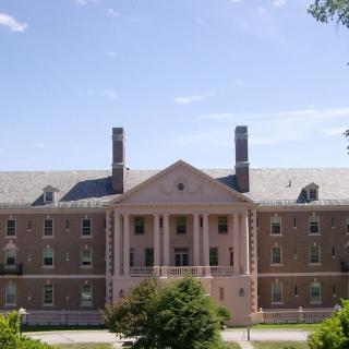 A historic university building with brick facade and symmetrical columns.
