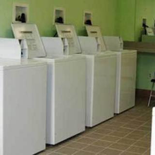A row of washing machines in a laundromat.