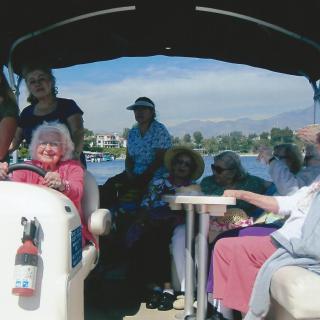 A group of seniors enjoying a leisurely boat ride on a sunny day.