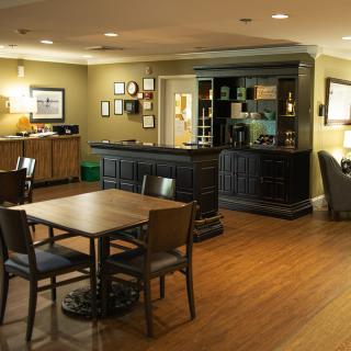 A cozy dining area with wooden furniture and warm lighting.