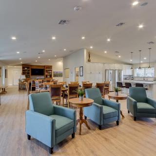 A spacious and modern living area featuring comfortable seating and elegant lighting.