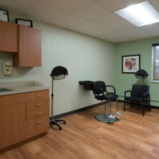 A clean, organized medical or salon room featuring chairs and modern furnishings.