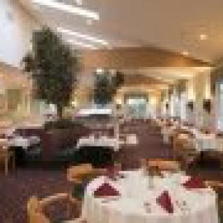 An elegant restaurant dining area with neatly set tables and chairs.