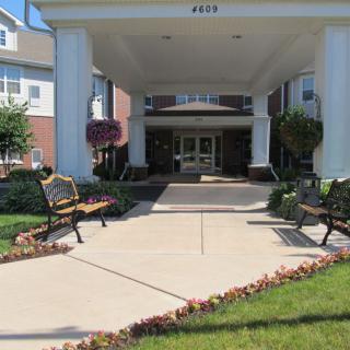 Entrance to a building with benches and landscaped area