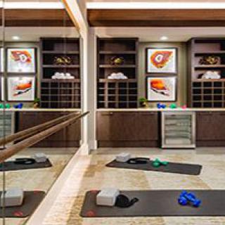 Modern yoga studio with exercise mats and fitness equipment.