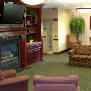 A cozy living room with a fireplace, television, and comfortable seating.