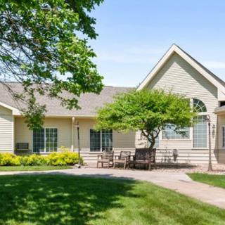 A charming house with a well-maintained yard and patio area.