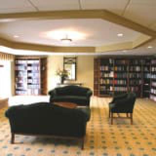 A cozy library interior with comfortable seating and bookshelves.