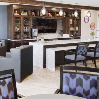 A modern lounge area featuring a stylish bar and comfortable seating.