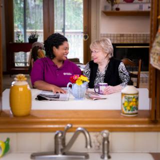 A warm moment shared between two individuals in a cozy kitchen, highlighting friendship and connection.