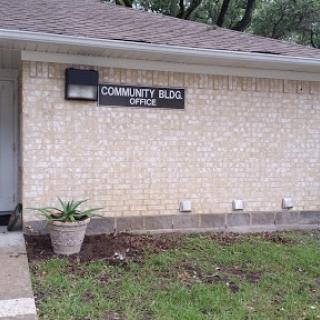 The exterior of a community office building featuring a clearly marked sign.