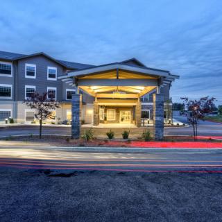 A well-lit hotel entrance during the evening.