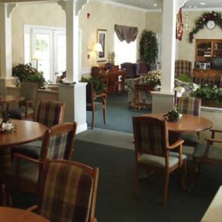 A cozy dining area with wooden chairs and tables, featuring classic decor.